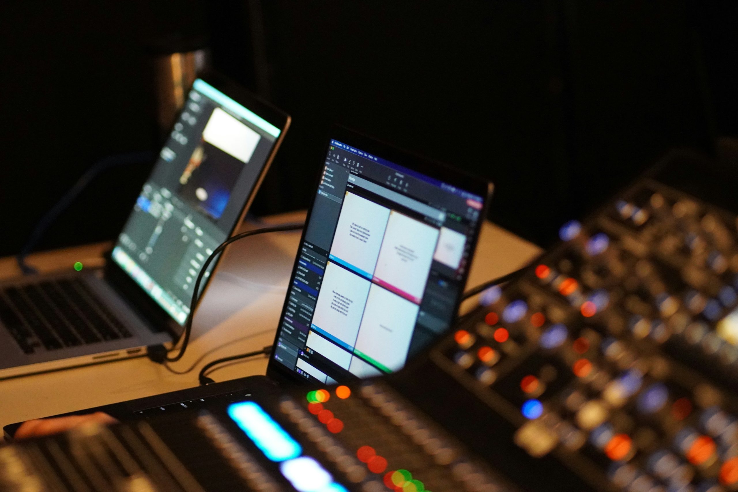 Audio technician station with laptop and control board.