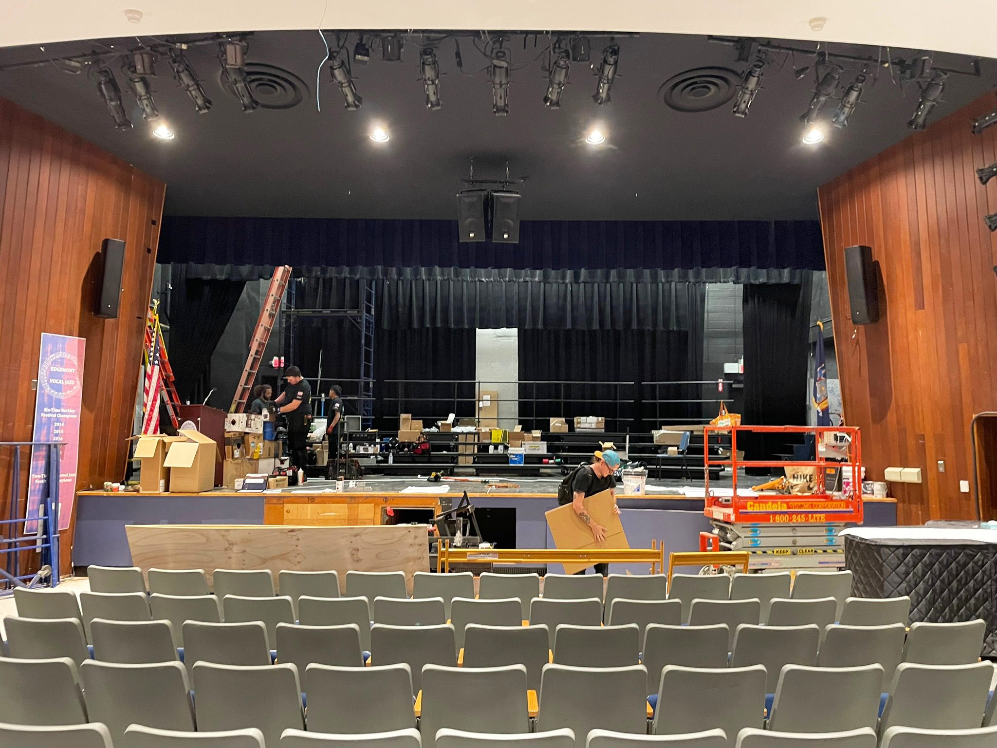 View of a theater auditorium with technical equipment being set up.